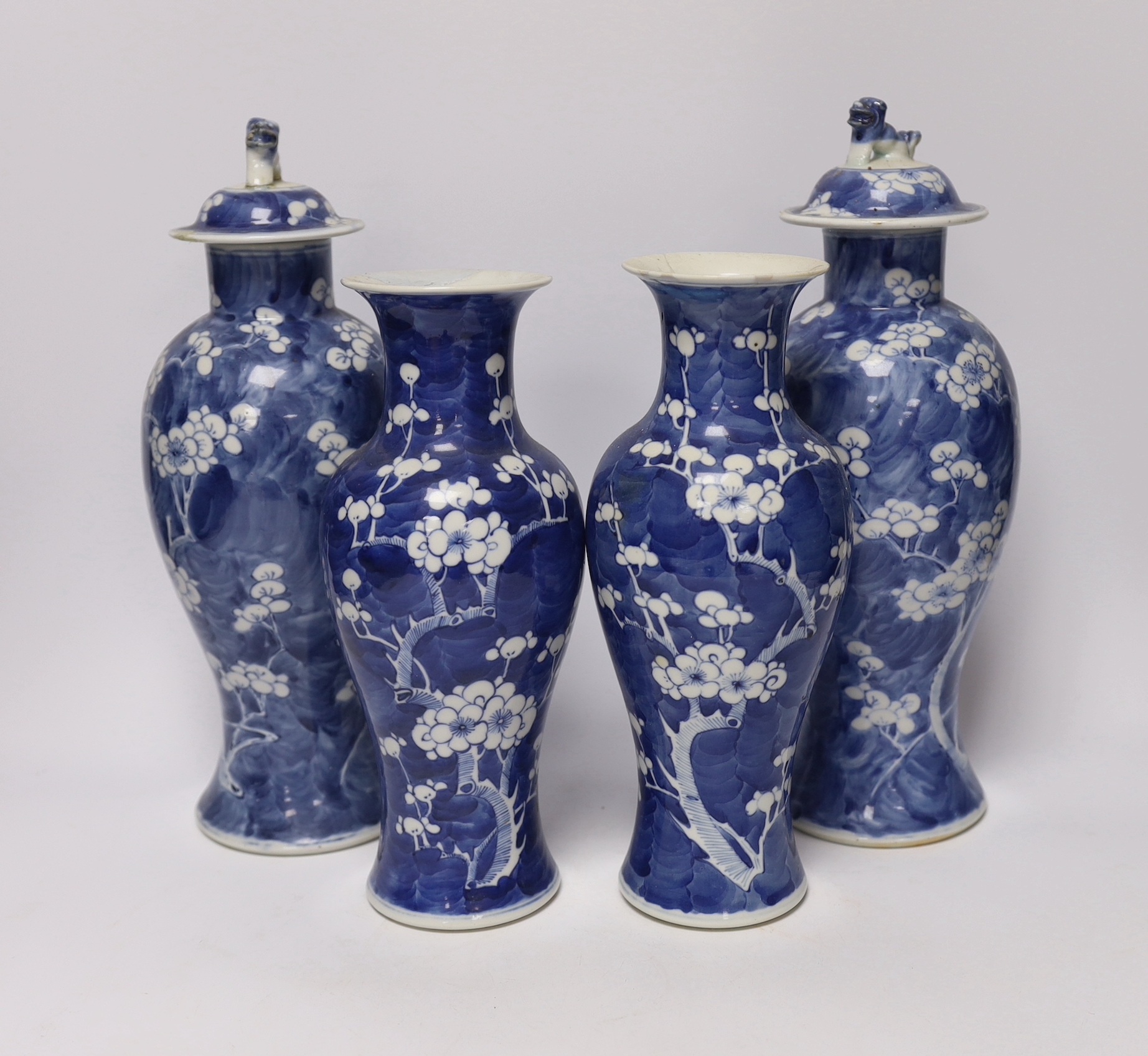 Two pairs of late 19th/early 20th century Chinese blue and white prunus vases, one pair with covers, tallest 30cm